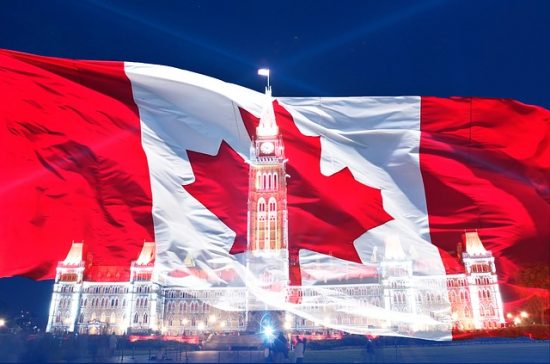 Canadian flag with silhouette of Parliament Buildings. Happy Canada Day!