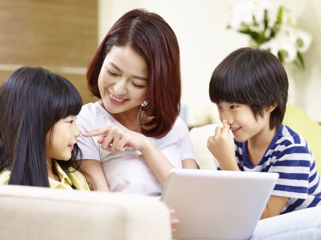 mother with two young children having fun together